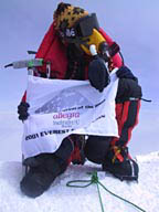 Erik Weihenmayer holding the NFB flag on the top of Mt. Everest.