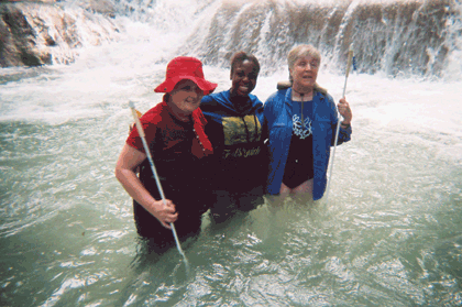 Ramona Walhof (left) and Seville Allen (right) stand with their tour guide in the falls.