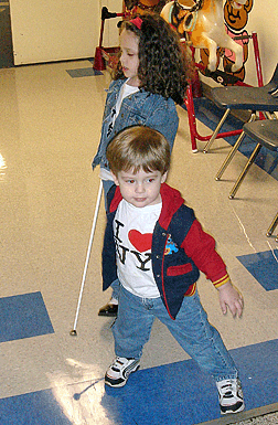 Now part of everyone�s routine, the cane goes virtually unnoticed by two-year-old R.J. as he simply loves to play with his big sister Kendra.