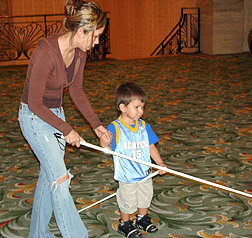 Melissa Fernandez and son, Jacob Trevino, TX, displaying the method of the �teaching cane.� Melissa holds the cane out in front to show Jacob how she is using it. 