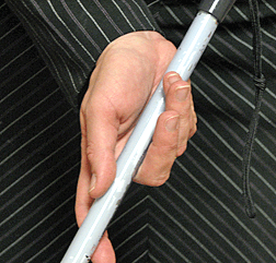 Now referred to as the �open palm technique,� the traditional grip has evolved in order to facilitate long periods of mobility and cane use without tiring. It also produces a wider arc as the index finger does not obstruct the cane�s motion. Here, the hand holds the cane with the palm open underneath. Shifting between the open and closed positions allows the cane to move from side to side more easily.