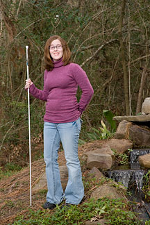 Kayleigh Joyner uses her long white cane on a summer outing.