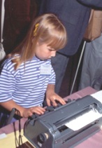 Young girl uses a Braillewriter.