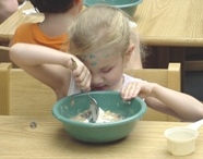 A little girl, Jodi Jones, stirs ingredients in a bowl.