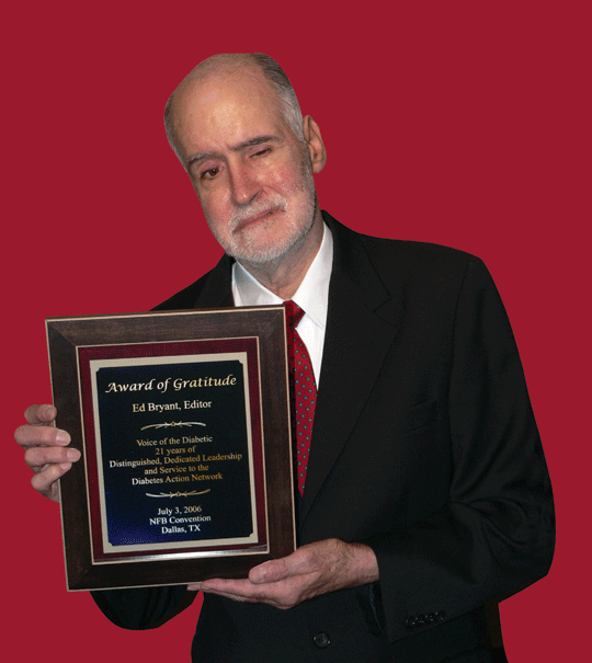 Ed Bryant standing with an award plaque from the Diabetes Action Network of the National Federation of the Blind. It reads: Award of Gratitude, Ed Bryant, Editor, Voice of the Diabetic, 21 Years of Distinguished, Dedicated Leadership and Service to the Diabetes Action Network, July 3, 2006, NFB Convention, Dallas, TX. Photograph courtesy of Vicki Palmer.