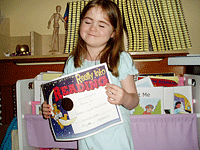 A you girl holds a reading certificate