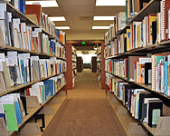 Aisle of shelves filled with books at the Jacobus tenBroek Library