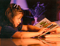 Profile of little girl reading Braille