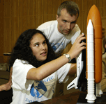 A Science Academy student explores a space shuttle model.