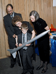 A blind child looks at a rocket model at the Grand Opening of the Jernigan Institute.